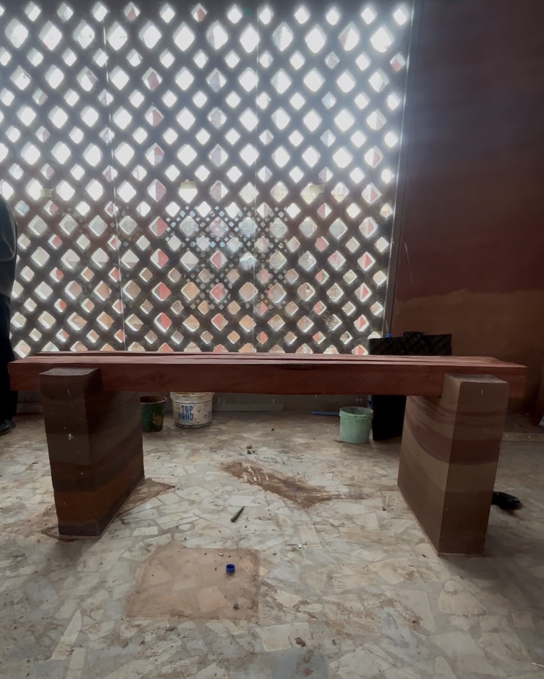 Rammed earth bench in a warm earth-toned interior